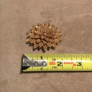 Gold tone starburst brooch